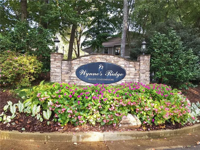 a sign that is sitting in front of flowers