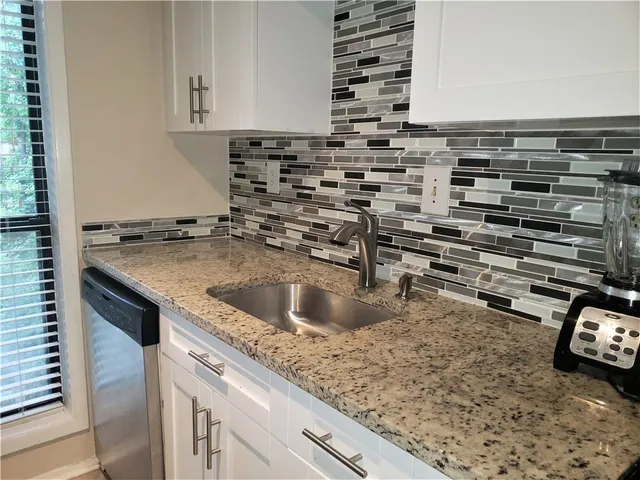 a kitchen with a sink and a stove top oven