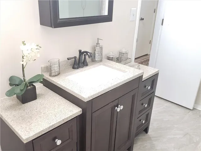 a kitchen with a sink a counter and cabinets