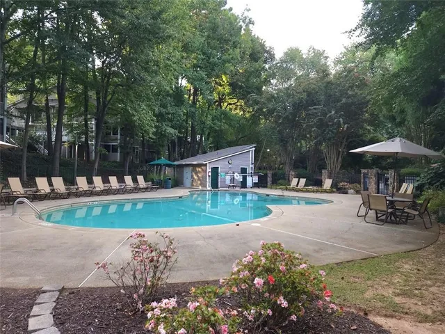 a view of a house with backyard and sitting area
