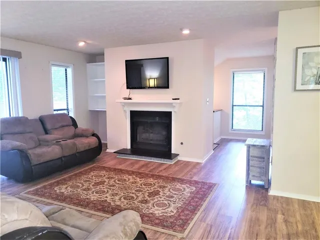 a living room with a flat screen tv and a fireplace