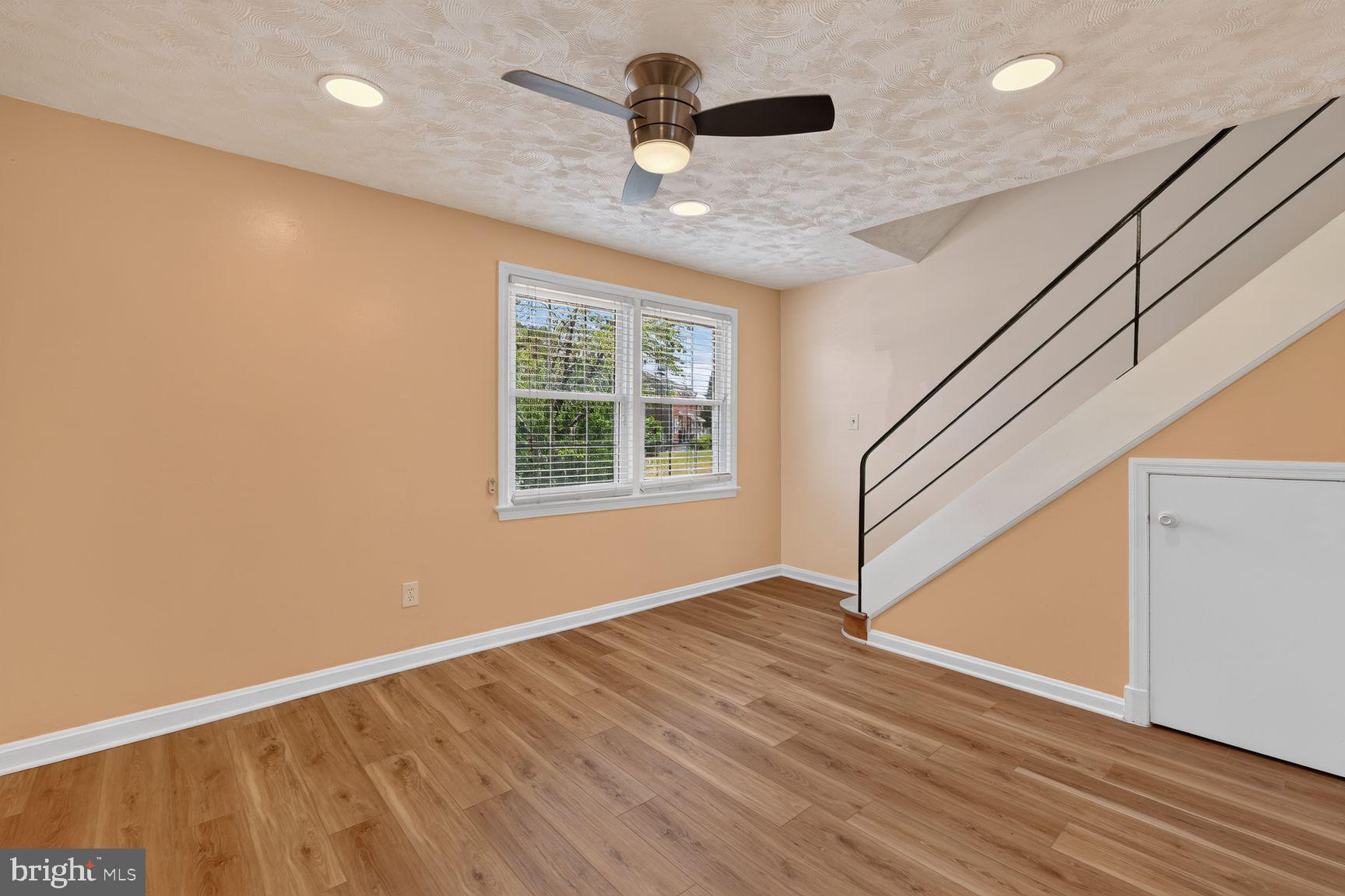 2437 Iverson Street Temple Hills, MD 20748 - Photo 2 of 15 an empty room with wooden floor chandelier fan and windows