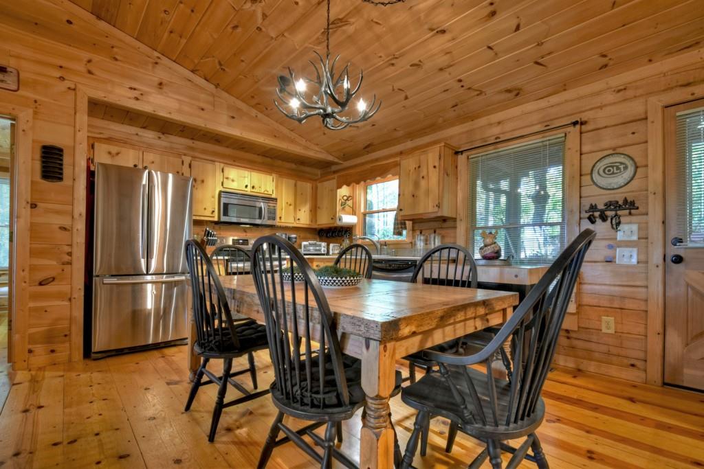9 Joanna Court Blue Ridge, GA 30513 - Photo 12 of 34 a view of a dining room with furniture a chandelier and wooden floor