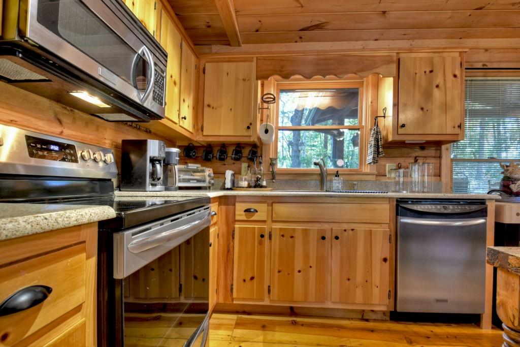 9 Joanna Court Blue Ridge, GA 30513 - Photo 14 of 34 a kitchen with stainless steel appliances granite countertop a stove and a sink