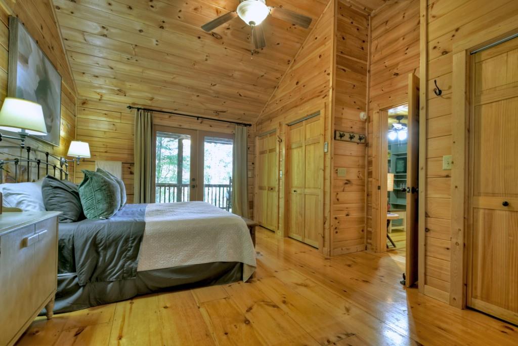9 Joanna Court Blue Ridge, GA 30513 - Photo 22 of 34 a spacious bedroom with a bed and wooden floor