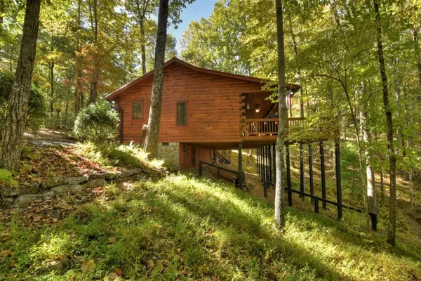 a backyard view with a couple of trees and entertaining space