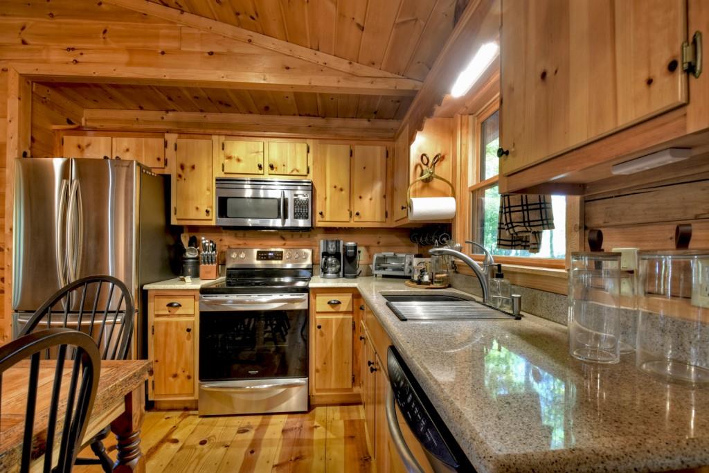 9 Joanna Court Blue Ridge, GA 30513 - Photo 5 of 34 a kitchen with stainless steel appliances granite countertop a stove a sink and a microwave