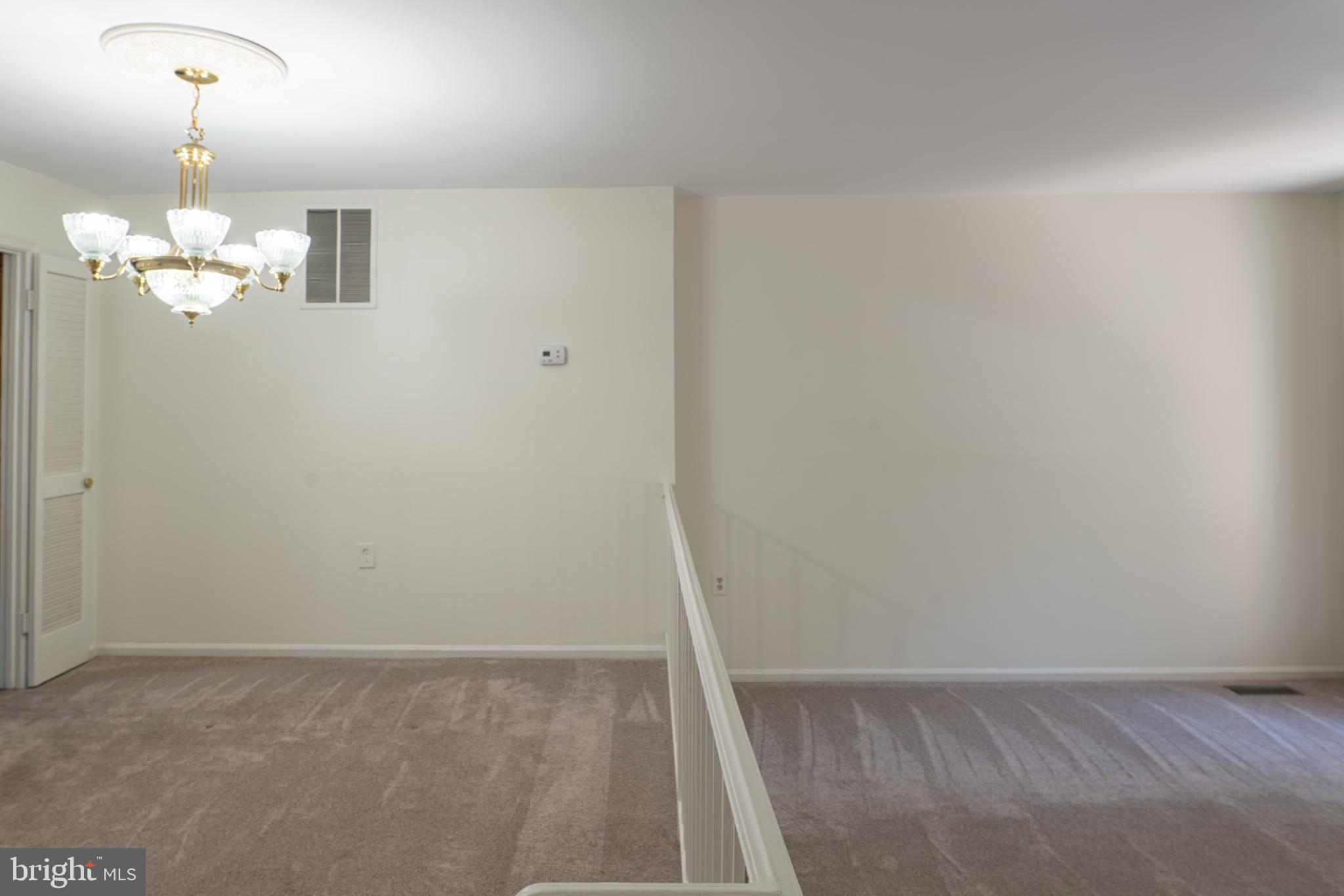 2913 Seminole Road Woodbridge, VA 22192 - Photo 7 of 34 a view of a room with wooden floor and chandelier