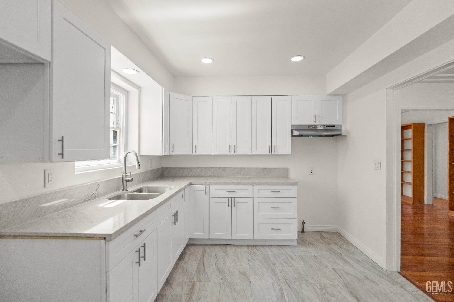 Undisclosed Address Bakersfield, CA 93305 - Photo 12 of 27 a kitchen with a sink cabinets appliances and a window