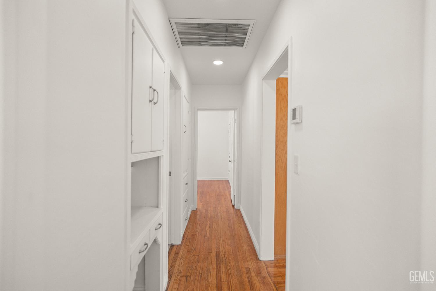 Undisclosed Address Bakersfield, CA 93305 - Photo 16 of 27 a view of a hallway with wooden floor
