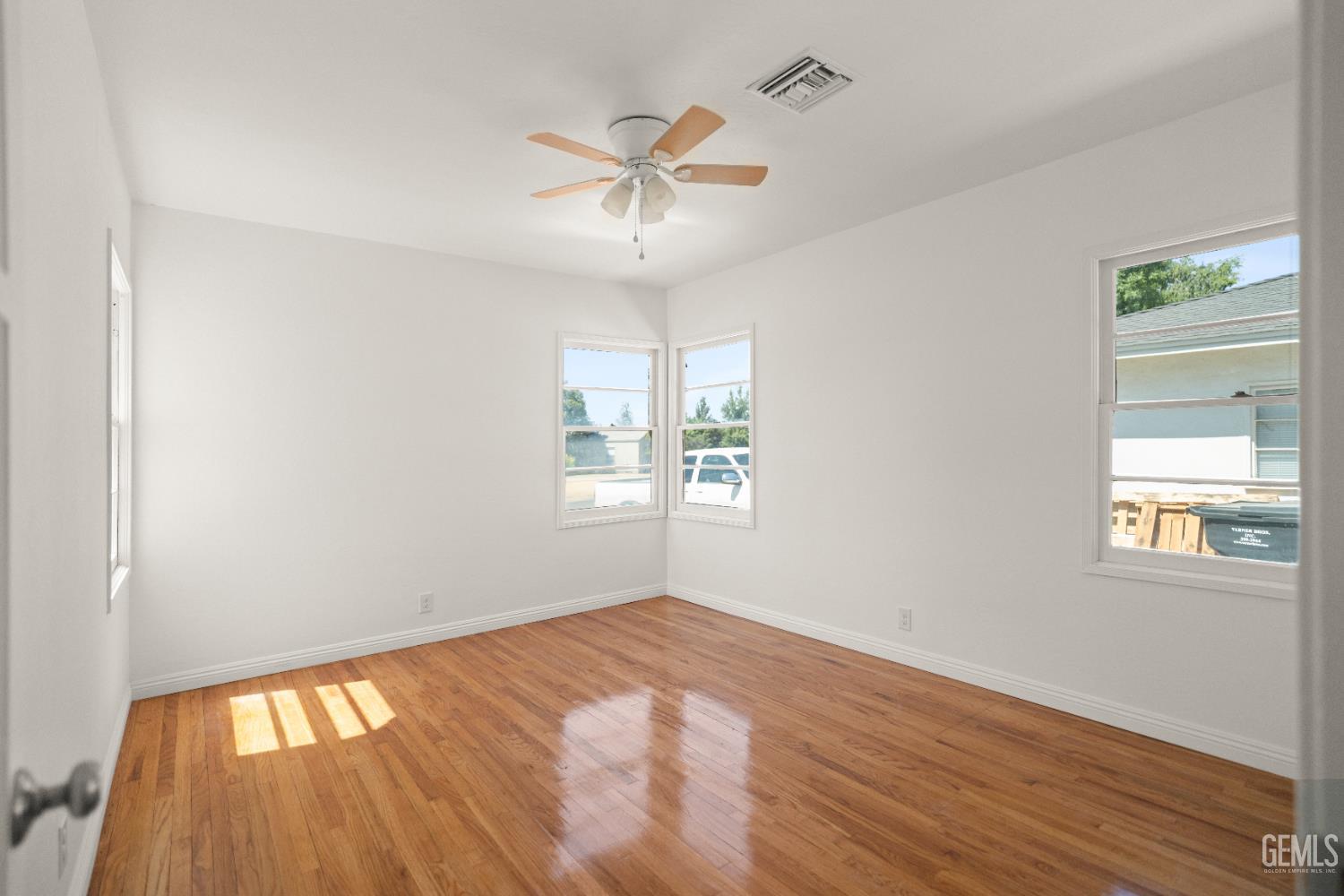 Undisclosed Address Bakersfield, CA 93305 - Photo 17 of 27 a view of an empty room with wooden floor and a window
