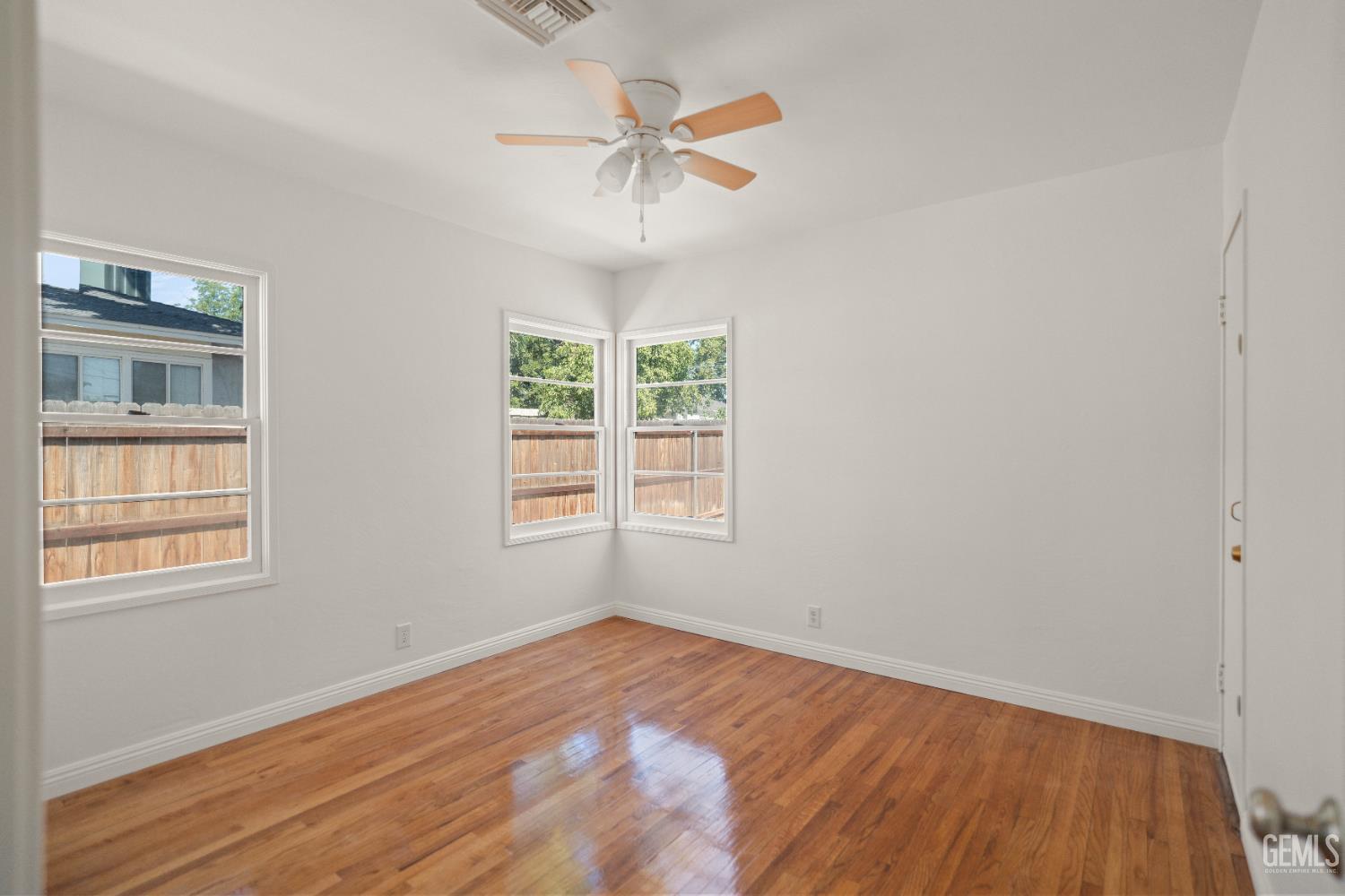 Undisclosed Address Bakersfield, CA 93305 - Photo 21 of 27 an empty room with a window and a ceiling fan