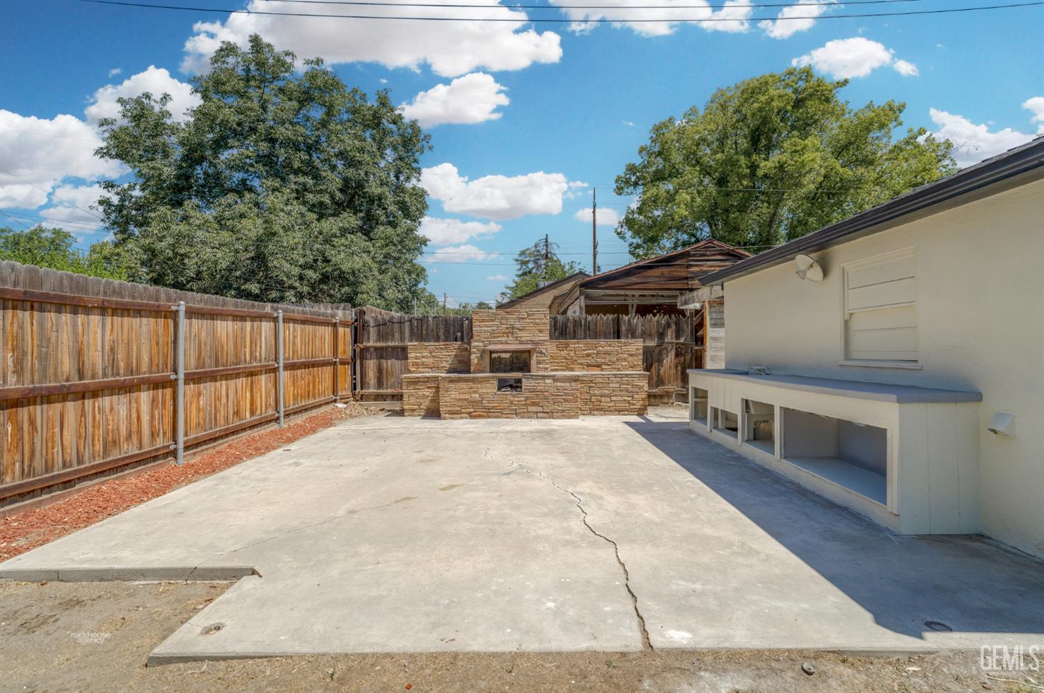 Undisclosed Address Bakersfield, CA 93305 - Photo 25 of 27 a view of a patio with table and chairs with wooden floor and fence