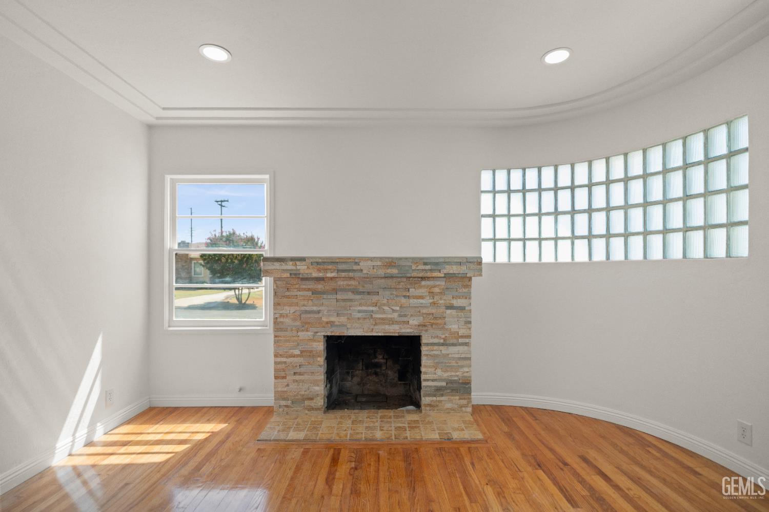 Undisclosed Address Bakersfield, CA 93305 - Photo 5 of 27 a view of a livingroom with wooden floor and a fireplace