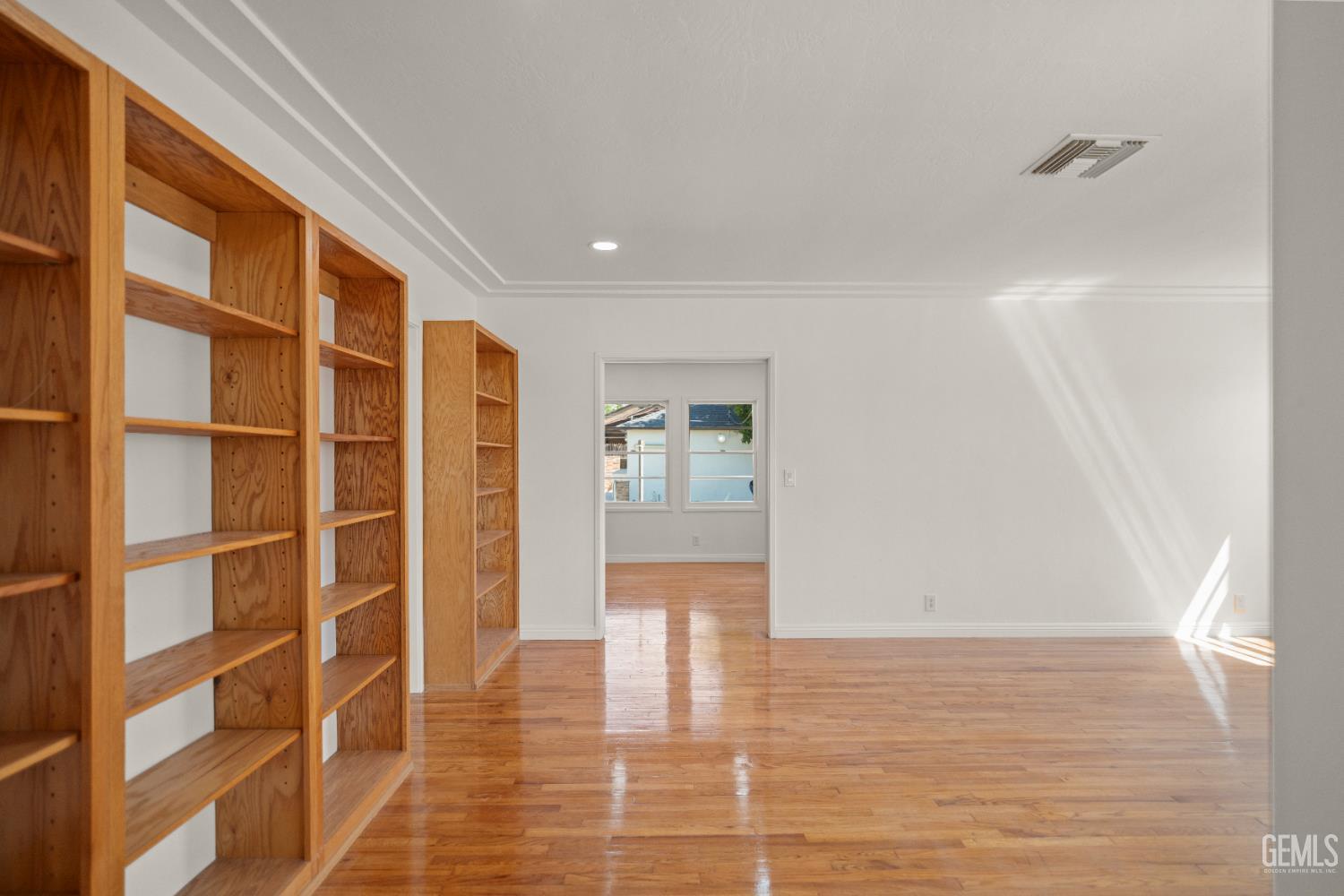 Undisclosed Address Bakersfield, CA 93305 - Photo 7 of 27 a view of an empty room with wooden floor and a window