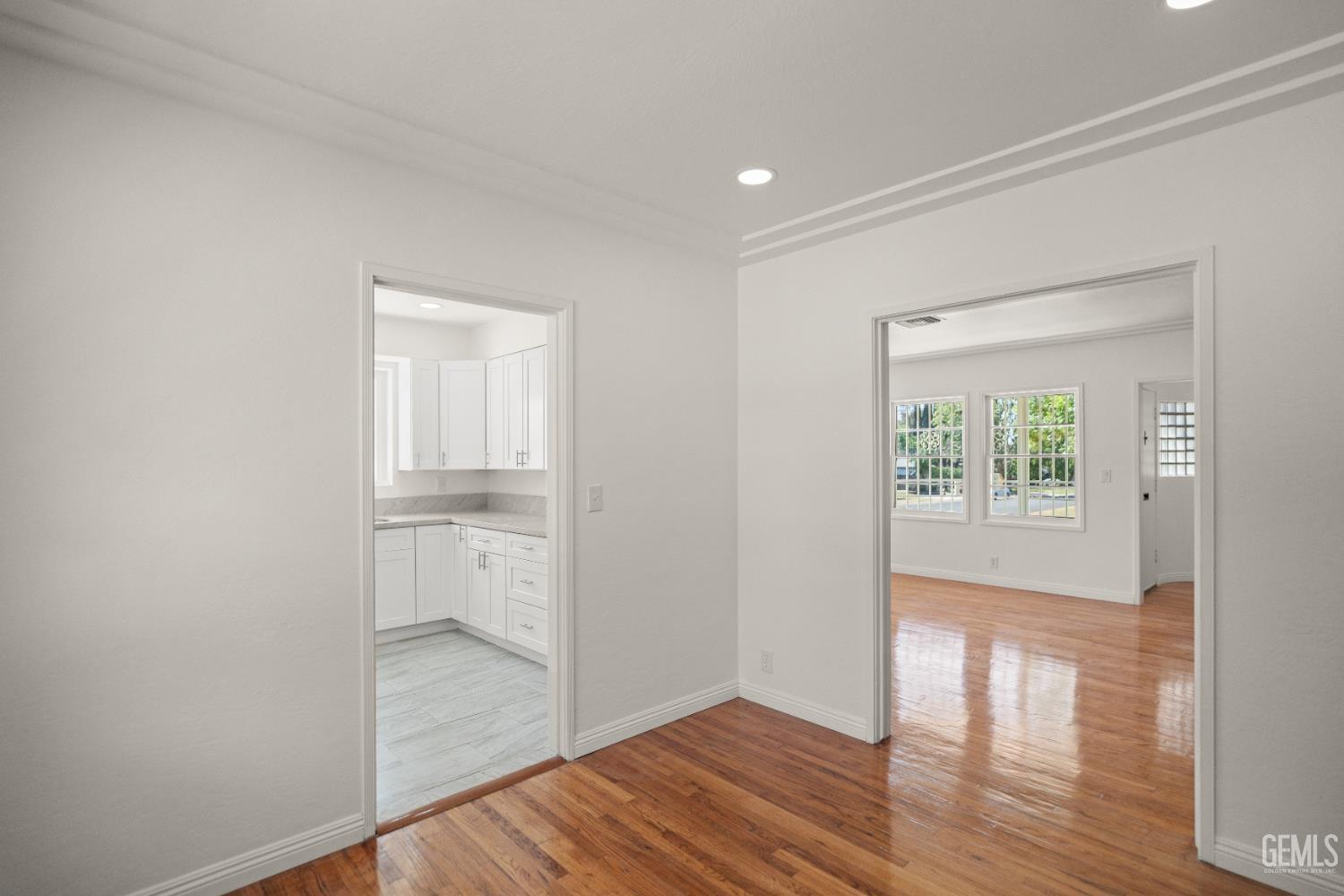 Undisclosed Address Bakersfield, CA 93305 - Photo 10 of 27 a view of empty room with wooden floor and fan
