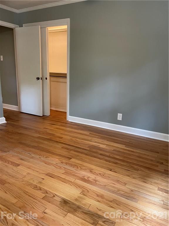 327 Ashbrook Road Salisbury, NC 28147 - Photo 12 of 27 a view of an empty room with wooden floor and a window