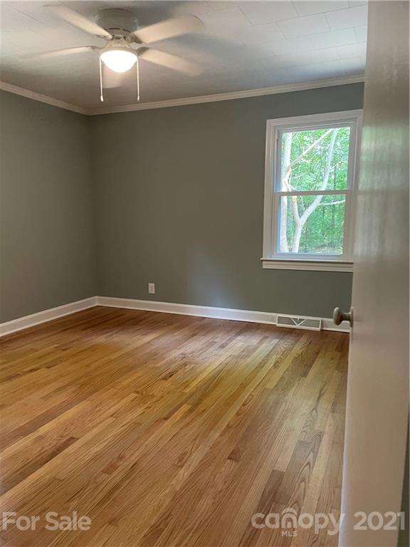 327 Ashbrook Road Salisbury, NC 28147 - Photo 17 of 27 an empty room with wooden floor and windows