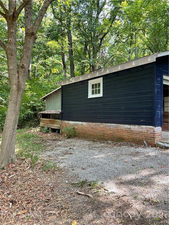 327 Ashbrook Road Salisbury, NC 28147 - Photo 22 of 27 a backyard of a house with large trees and wooden fence