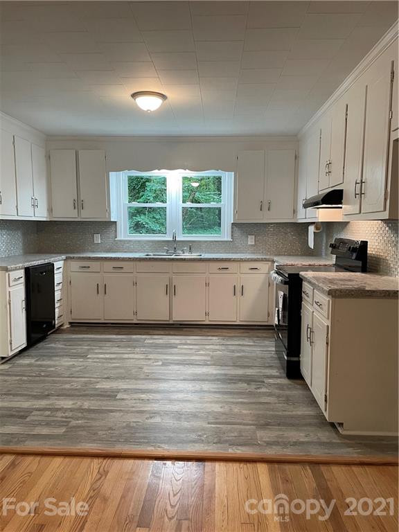 327 Ashbrook Road Salisbury, NC 28147 - Photo 4 of 27 a view of a kitchen with wooden floor and cabinets