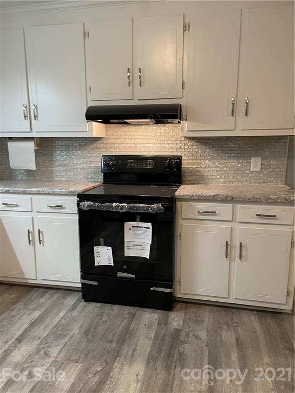 327 Ashbrook Road Salisbury, NC 28147 - Photo 5 of 27 a kitchen with granite countertop white cabinets and a stove