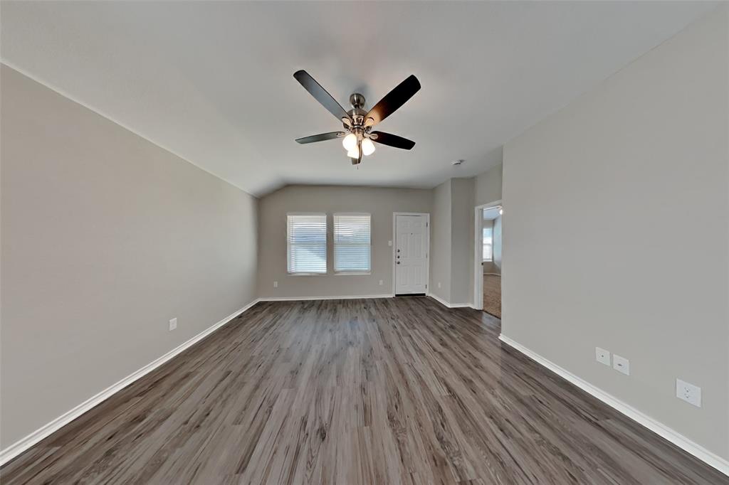 6285 Spring Buck Run Fort Worth, TX 76179 - Photo 2 of 18 an empty room with wooden floor and windows