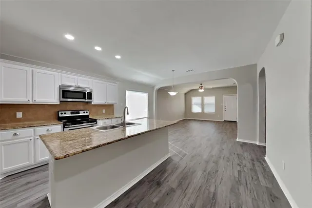 a view of a kitchen with sink and wooden floor