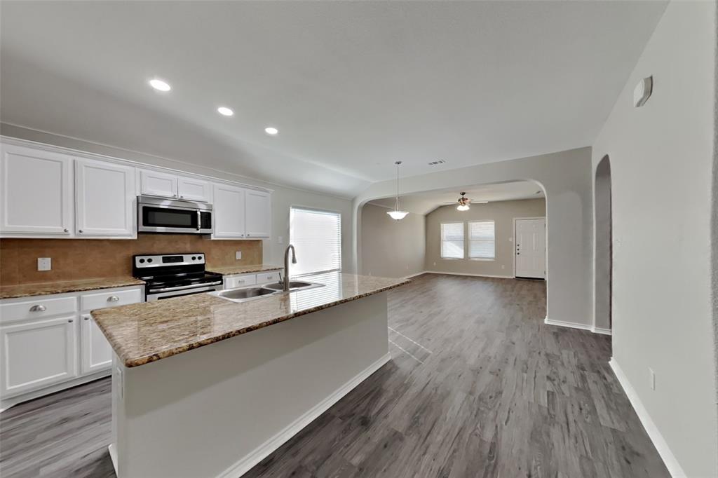 6285 Spring Buck Run Fort Worth, TX 76179 - Photo 3 of 18 a view of a kitchen with sink and wooden floor