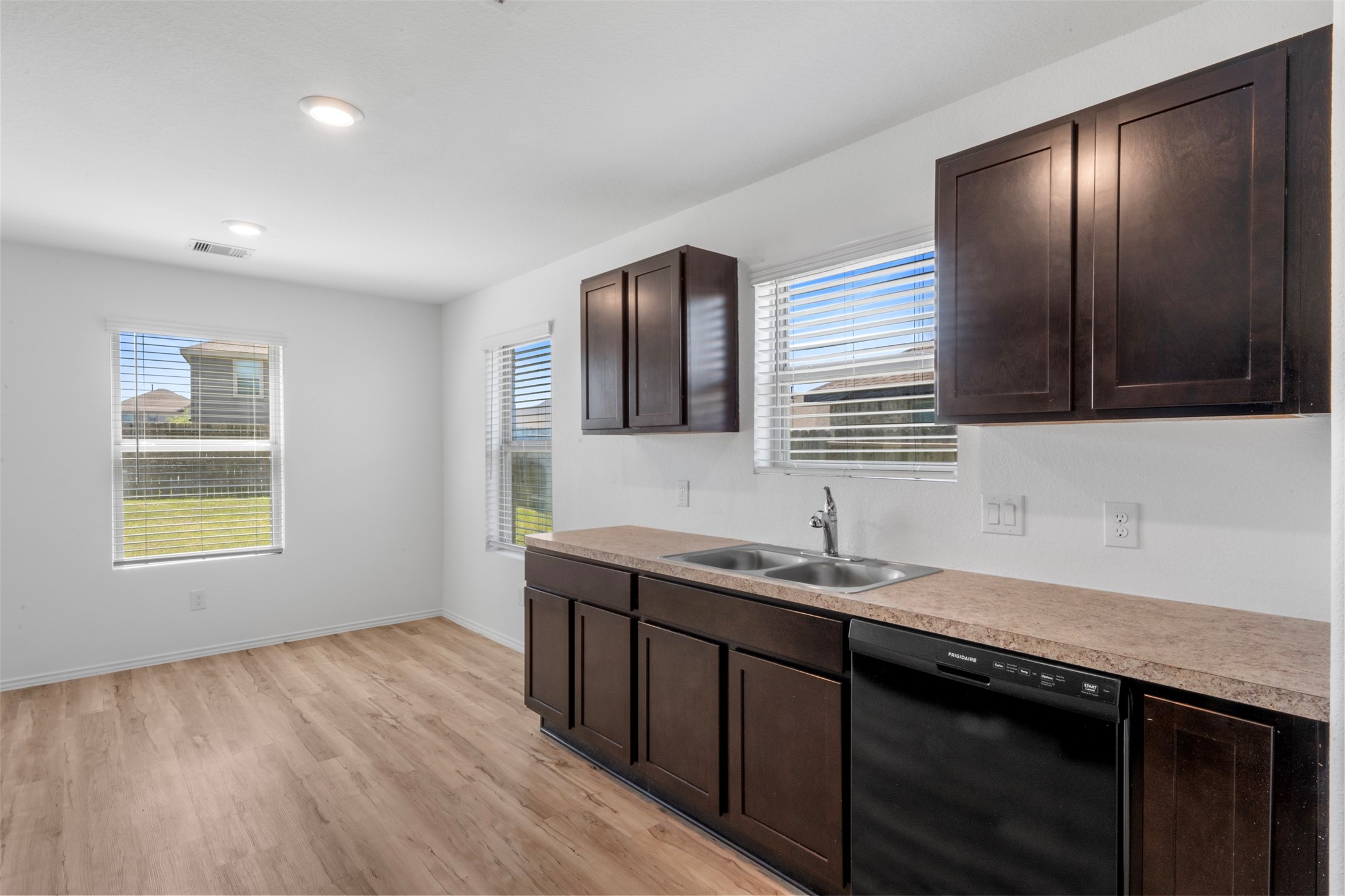 14602 Broadbury Pond Road Rosharon, TX 77583 - Photo 12 of 22 a kitchen with a sink stove and cabinets