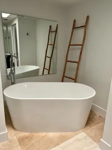 a white toilet sitting next to a bath tub