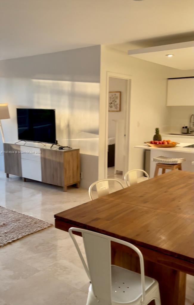 101 Crandon Boulevard, Unit 381 Key Biscayne, FL 33149 - Photo 10 of 16 a living room with stainless steel appliances kitchen island granite countertop a sink and a stove with wooden floor
