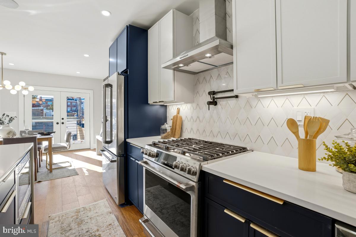 1621 D Street Northeast Washington, DC 20002 - Photo 11 of 31 a kitchen with stainless steel appliances granite countertop a sink stove and refrigerator