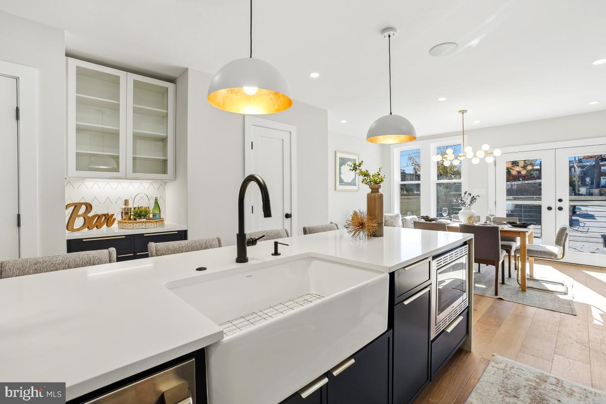 1621 D Street Northeast Washington, DC 20002 - Photo 12 of 31 a kitchen with a sink a counter and chairs