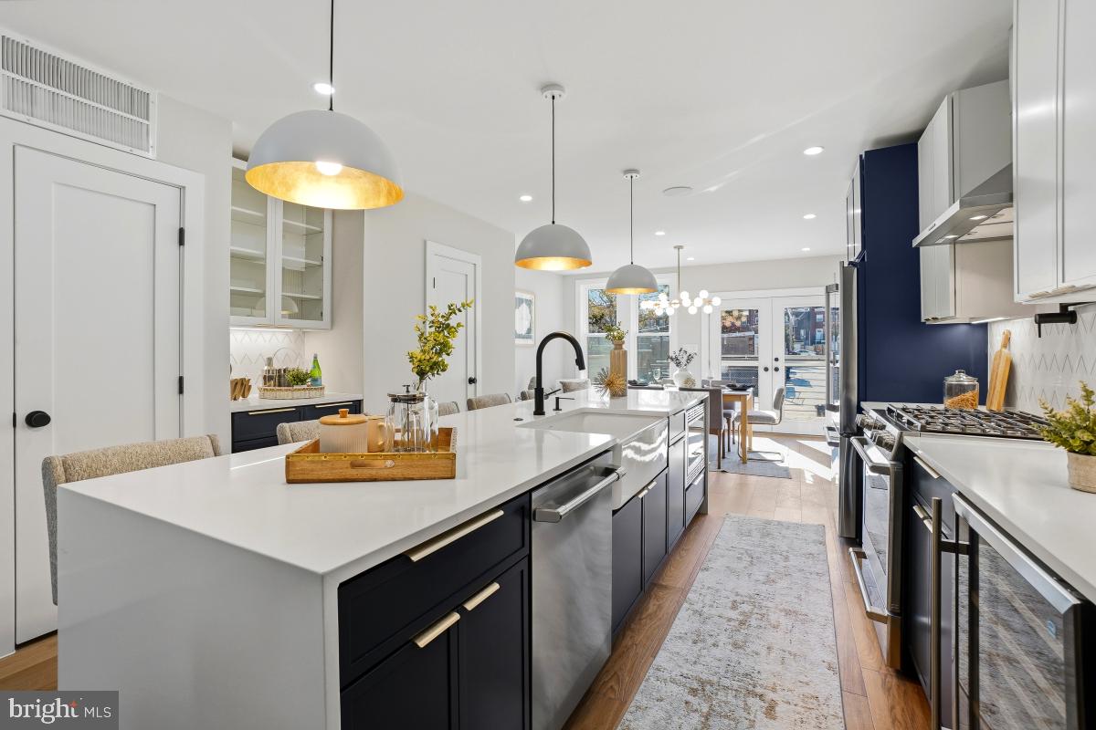 1621 D Street Northeast Washington, DC 20002 - Photo 8 of 31 a kitchen with stainless steel appliances a sink stove and refrigerator