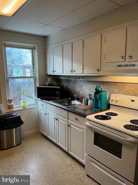 1022 North Lime Street Lancaster, PA 17602 - Photo 2 of 4 a kitchen with granite countertop white cabinets and white appliances