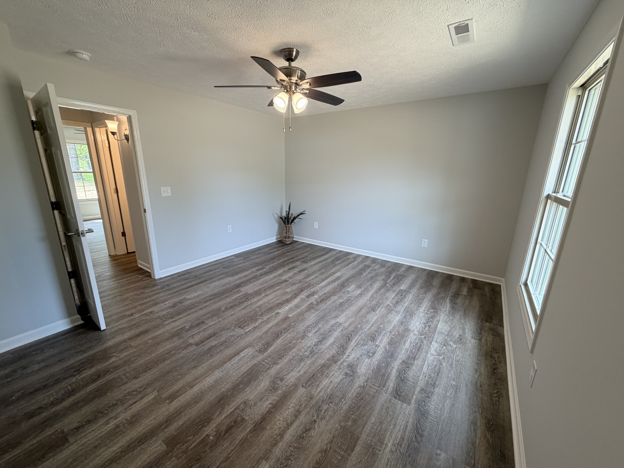 6265 Lynchburg Road Winchester, TN 37398 - Photo 35 of 55 an empty room with wooden floor and a ceiling fan