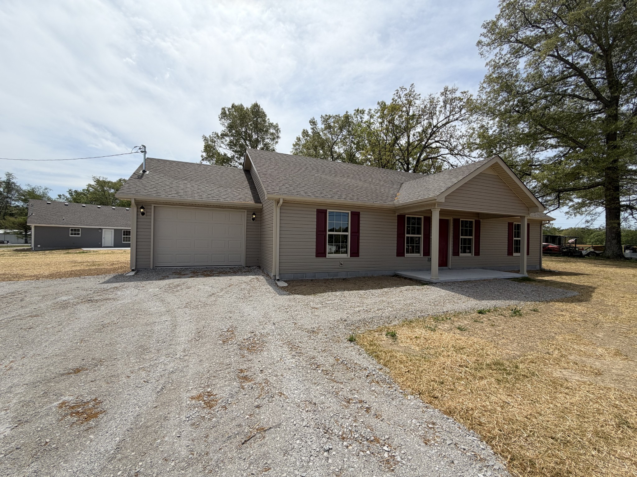 6265 Lynchburg Road Winchester, TN 37398 - Photo 50 of 55 a front view of a house with a yard and garage