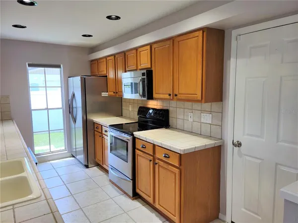 a kitchen with a stove a sink and a refrigerator