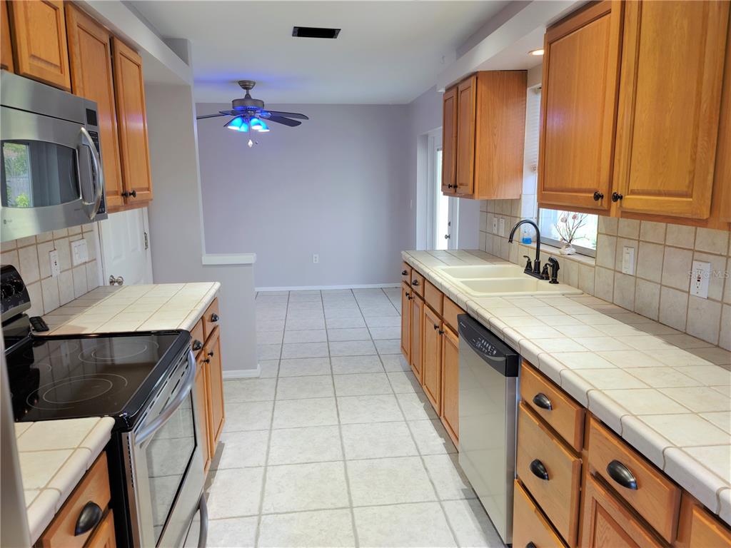979 Nantucket Road Venice, FL 34293 - Photo 14 of 34 a kitchen with a sink stove and cabinets