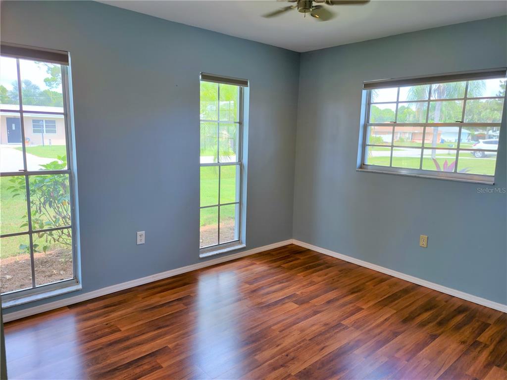 979 Nantucket Road Venice, FL 34293 - Photo 27 of 34 a view of an empty room with wooden floor and a window