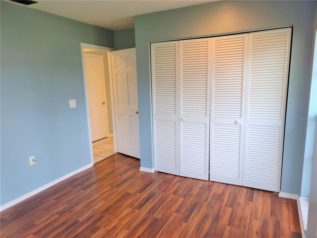 979 Nantucket Road Venice, FL 34293 - Photo 28 of 34 an empty room with wooden floor and closet