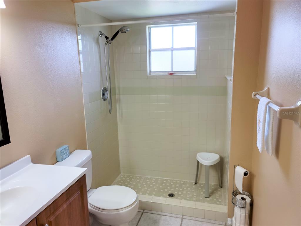 979 Nantucket Road Venice, FL 34293 - Photo 30 of 34 a bathroom with a sink a toilet a window and shower