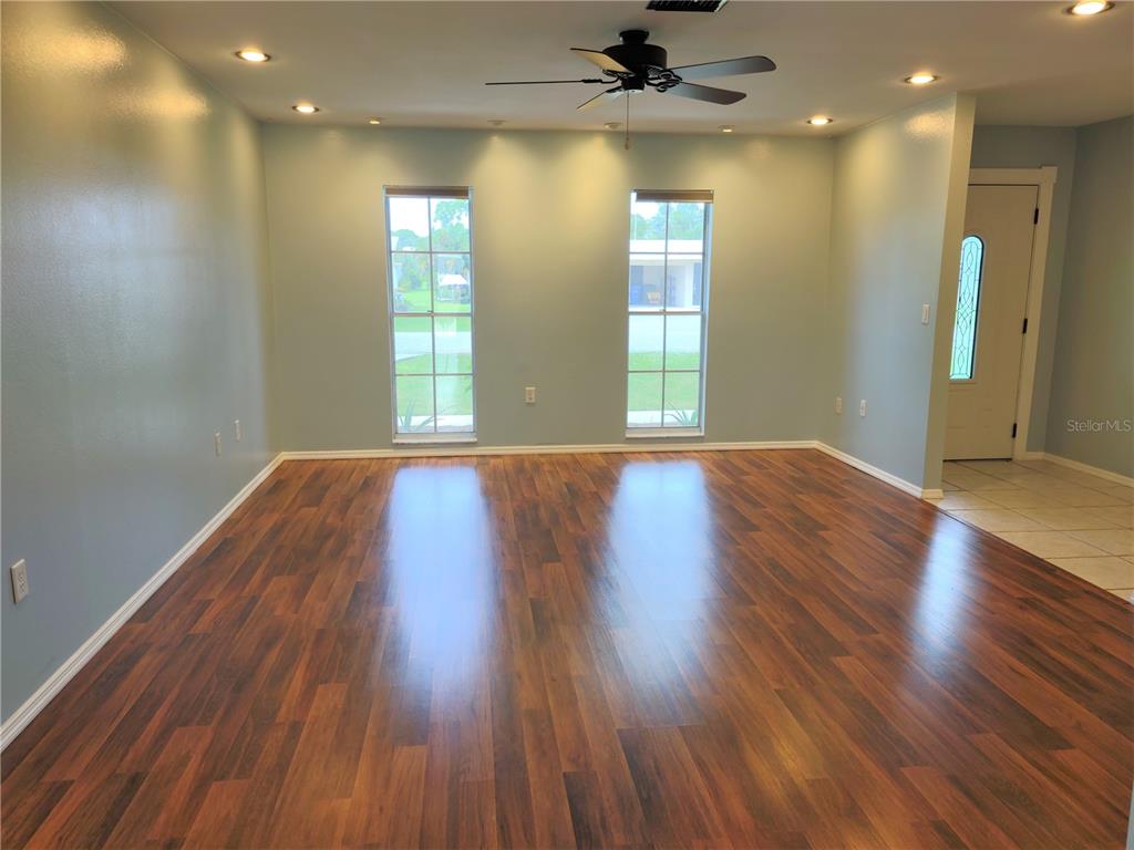 979 Nantucket Road Venice, FL 34293 - Photo 3 of 34 a view of an empty room with wooden floor and a window