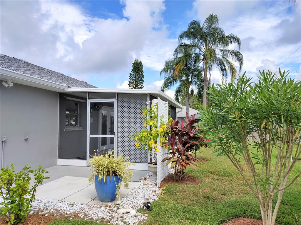 979 Nantucket Road Venice, FL 34293 - Photo 33 of 34 a vase of flowers sitting on a floor in front of a house