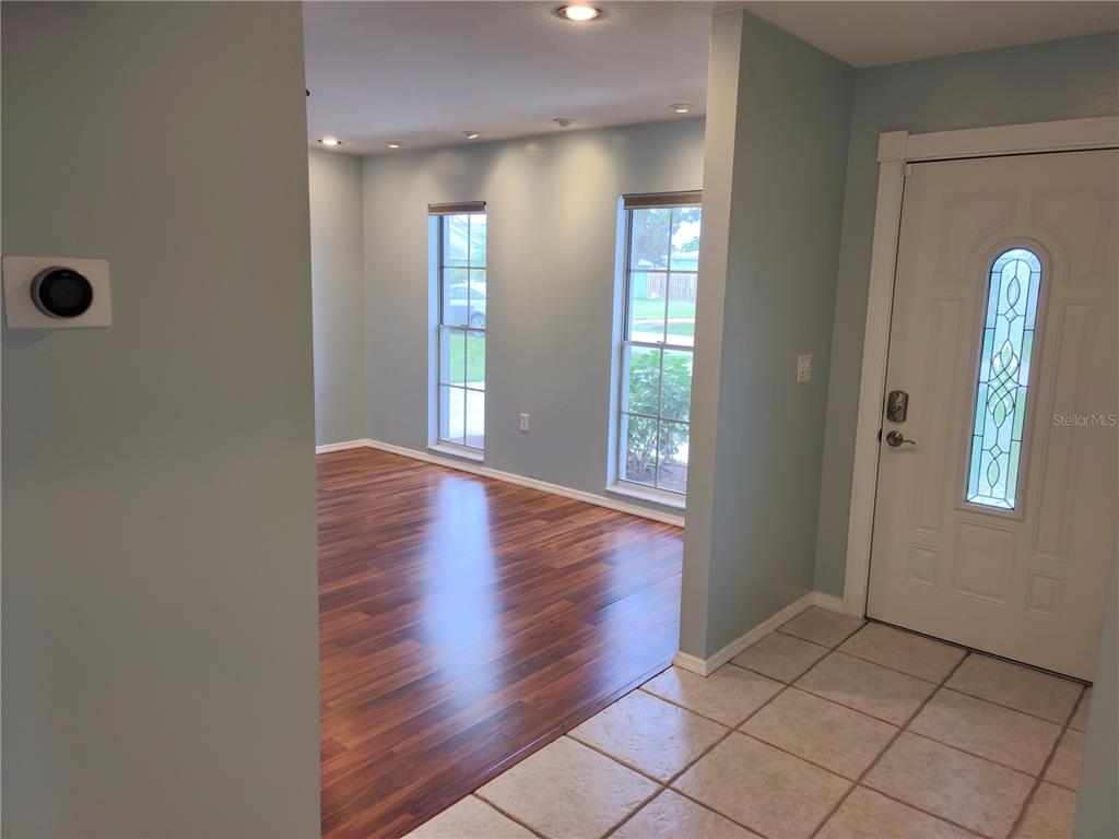 979 Nantucket Road Venice, FL 34293 - Photo 4 of 34 wooden floor in an empty room with a window
