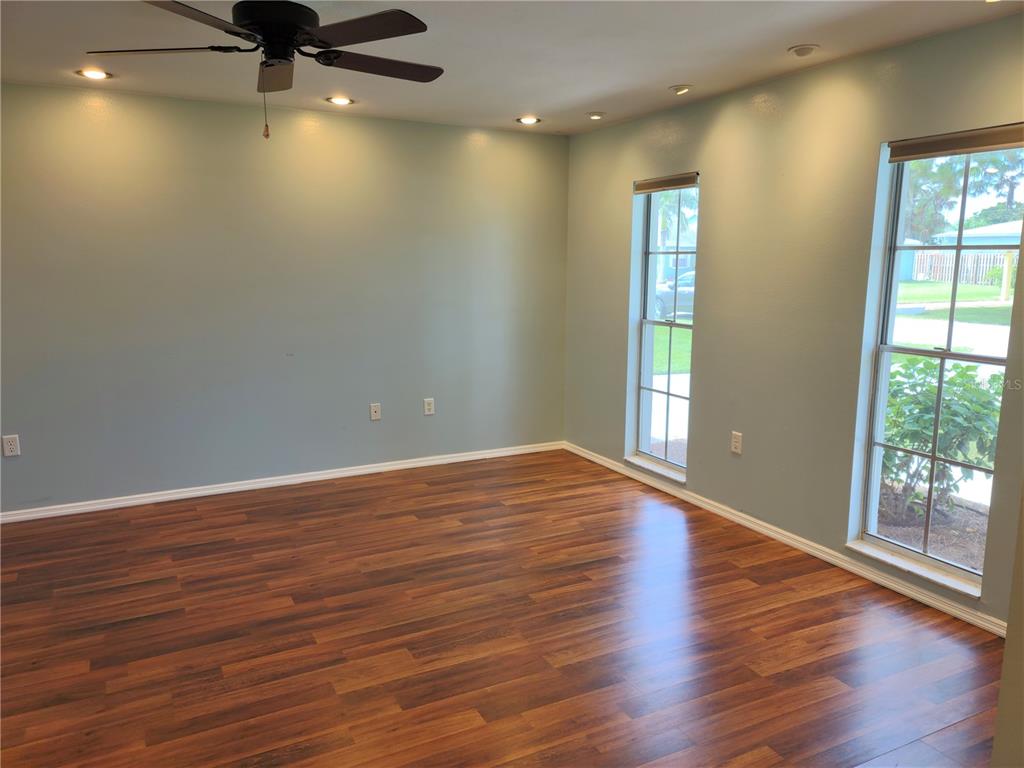 979 Nantucket Road Venice, FL 34293 - Photo 5 of 34 wooden floor in an empty room with a window