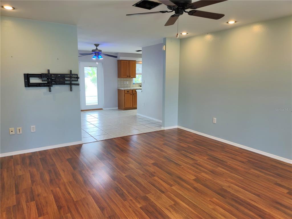979 Nantucket Road Venice, FL 34293 - Photo 6 of 34 wooden floor in an empty room with a window