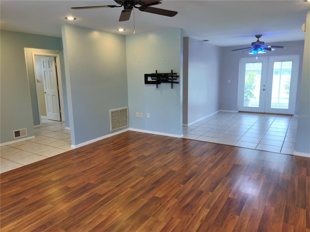 979 Nantucket Road Venice, FL 34293 - Photo 7 of 34 wooden floor in an empty room with a mirror