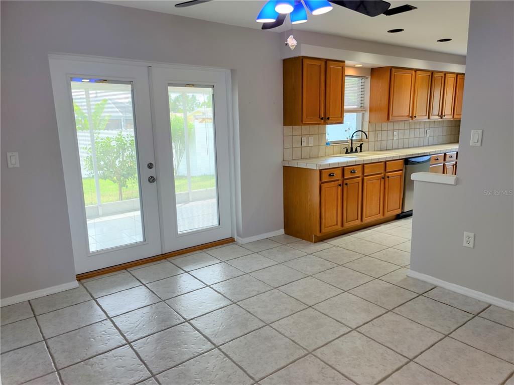 979 Nantucket Road Venice, FL 34293 - Photo 10 of 34 a kitchen with stainless steel appliances a sink window and cabinets