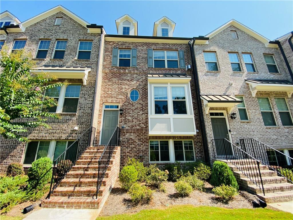 1815 Hislop Lane, Unit 8 Atlanta, GA 30345 - Photo 1 of 38 a front view of a house with a yard